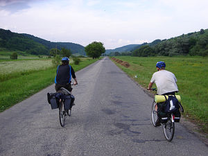 Cycling in Transylvania - two cyclists on a paved road
