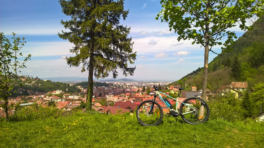 Cycling tour in Brasov - city view with a bike